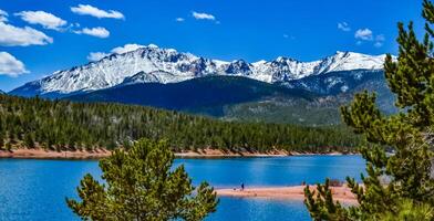 Panorama Snow-capped and forested mountains near a mountain lake, Pikes Peak Mountains in Colorado Spring, Colorado, US photo