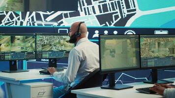 Diverse employees following the delivery track through city traffic, offering directions for less crowded street routes to ship cargo. Operators managing order tracking complains. Camera A. photo