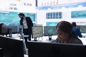General director employing big data to help in solving tasks in control room, operating on huge screen to create a performance metrics analysis. Manager ensuring organizational efficiency. photo