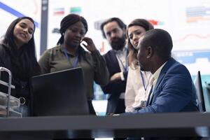 Angry displeased team of workers failing to accomplish enterprise goals, frustration in the business monitoring room. Displeased sad supervisor and associates during meeting. photo