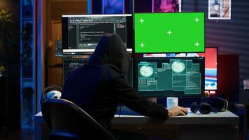 Spy using green screen PC in secret hideout to steal valuable data by hacking, getting attacks rejected by security. Hacker using mockup monitor seeing access denied error message, camera A photo