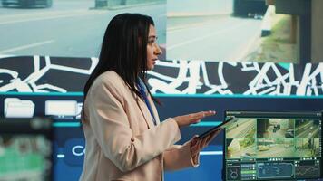 Indian supervisor gather intelligence on cargo delivery logistics by following the route through street traffic via satellite map. Manager works with her team in control center. Camera A. photo