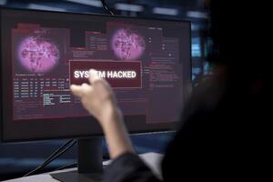 Admin in server hub establishment frightened by hacker passing firewall and stealing data. Close up shot of security breach notification on monitor in data center making IT expert panic photo