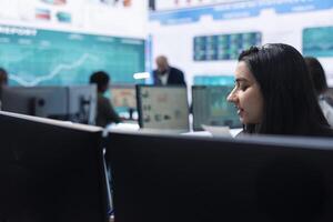 Business administrator examining data for the investors group, reviewing key performance indicators during annual analysis. Manager works on data management, enterprise workflow. photo