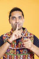 Authoritative man doing shushing hand gesturing, demanding secrecy, irritated by noise. Stern person complaining, placing finger on lips, doing quiet warning sign gesture, close up shot photo