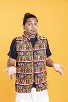 Portrait of doubtful man shrugging shoulders, unable to provide answer, isolated over studio background. Hesitant person doing perplexed hand gesturing, showing lack of knowledge photo