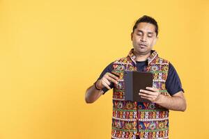 Man with dejected look on face after lacking necessary money, trying to buy stuff online. Person with disappointed facial expression after getting transaction rejected on device, studio background photo