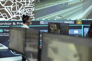 Indian call center operator gives parcel shipment updates to clients, handling delay complains in control center. Cargo shipping agency gives directions for trucks on less busy routes. photo