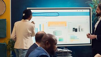 Employees team sharing insight on sales statistics in corporate briefing meeting, providing initiatives to enhance operational efficiency and agility. Group of business associates. Camera A. photo