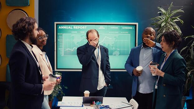 Concerned project manager trying to gather all important information to corelate with company objectives, working with his team to achieve development. Business people analyze reports. Camera A. photo