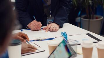 Entrepreneurs signing a new partnership contract between their firms, joining forces to capitalize on synergies. Managers collaborate to resolve specific skill gaps and development needs. Camera A. photo