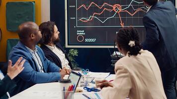 Startup team evaluating infographics data in an executive meeting, corporate restructuring or organizational changes. Adapting the organization to evolving market conditions. Camera A. photo