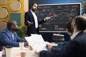 Chief operating officer presenting project goals and resource allocation during a meeting, creating successful pitch to present his ideas. Review performance indicators and marketing strategies. photo