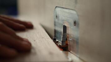 Woodworker operating spindle moulder to create high quality bespoke joinery for customer commissioned project. Machinist at work performing tasks on wood shaper, shaping materials, camera A close up photo