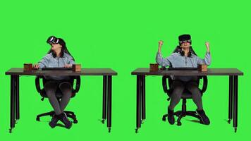 POV of gamer using virtual reality on pc games and winning, feeling proud and happy with her championship victory. Woman with vr headset at desk playing shooter contest. Camera A. photo