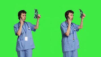 Nurse explaining disease diagnosis from x ray to patient on phone call, offering support to person receiving treatment and advice. Specialist examines radiology scan on the telephone line. Camera B. photo