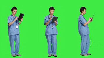 Nurse doing online shopping with credit card banking transaction, paying for items on store website. Medical assistant purchasing things on internet, e commerce ordering against greenscreen. Camera A. photo