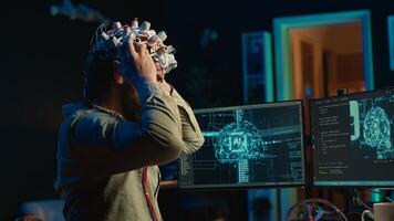 Man puts EEG headset on to transfer mind into computer virtual world, becoming one with AI superintelligence. Engineer using futuristic neuroscientific technology to transfer consciousness, camera A photo