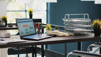 Documents on laptop screen in office containing business financial information income statements. Company invoice files displayed on notebook monitor in accounting workspace photo
