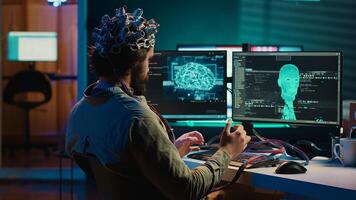Computer engineer trying to make EEG headset work, researching brain machine transferring. Man doing SF online consciousness uploading, trying to transcend out of simulation, camera A photo