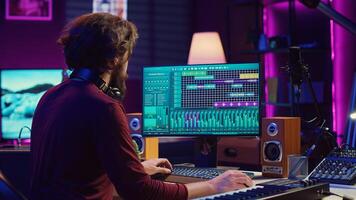 Audio engineer working at home music studio with daw software and equalizer mixing gear on screen. Performer mixing and mastering pop rock soundtracks, signal processing concept. Camera A. photo