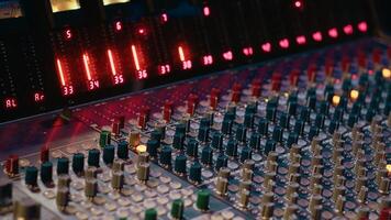 Control room panel board with buttons and switchers serve as mechanical and technical equipment of recording and mixing sound. Empty professional soundproof music studio. photo