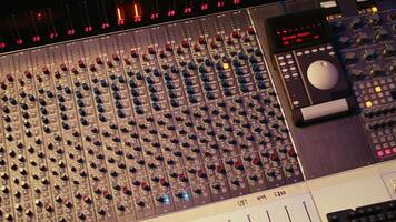 Empty professional recording studio with audio software on pc and control desk buttons or sliders. Technical equipment used to mix and master tracks, editing in post production. photo