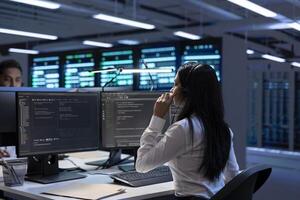 Team of specialists in data center call center responsible for providing logistics support to companies. Coworkers in server farm overseeing hardware systems and communicating with engineers photo