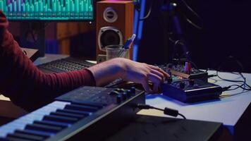 Sound engineer recording and producing audio for music industry, operating on mixing console and daw software in home studio. Musician ensuring optimized acoustics, mastering tracks. Camera A. photo