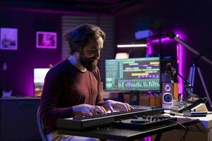 Musician playing electronic keyboard notes and recording tunes for mix and master session, using daw software interface to produce new music. Artist composing songs on piano midi controller. photo