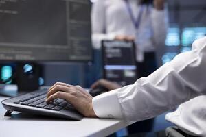 IT specialist ensuring server farm systems provide redundancy, automatic failover and rapid reconfiguration of clusters to minimize failure of individual machines, close up shot photo