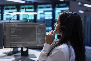 Data center support specialist performing systems integration activities, supporting engineering team doing hardware maintenance. Employee in server hub coordinating technicians photo