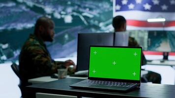 American army working in a command post with green screen, soldiers examining satellite imagery for clues regarding a national safety operation. US military control tower for surveillance. Camera A. photo
