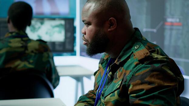 Army professionals in command post overseeing satellite data and real time surveillance, mission intelligence. Support strategic military operations, studying world map and big screen. Camera A. photo