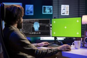 Sentient AI on green screen monitor interacting with computer engineer, greeting him after modifying own source code. Self aware artificial intelligence on mockup PC becoming alive photo