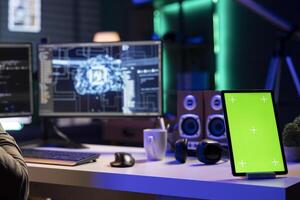 IT specialist scripting artificial intelligence on computer with isolated screen phone on desk next to it. Developer working on coding AI on desktop PC with mockup smartphone near photo
