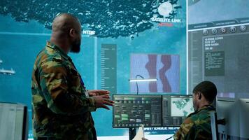 Military team operating in a high tech command post control tower, focusing on surveillance tactics for intelligence gathering. Data protection to manage critical information operations. Camera A. photo