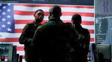 American army officers in a high tech command center monitor cybersecurity threats, manage classified information and state secrets. Hybrid warfare strategy for the government. Camera A. photo