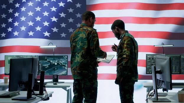 US soldiers in a high tech command center protecting classified information, ensuring cybersecurity and defending against cyber attacks. Army base of operations with trained officers. Camera A. photo