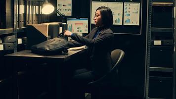 Private detective gathering necessary information from files records in incident room, leaving for field work to follow potential lead. Law agent examines forensic evidence in archive. Camera A. photo