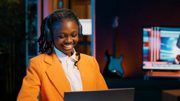 Young woman participating in online debate forums or academic competitions to learn case studies relevant to university coursework. African american girl listening to web webinar. Camera A. photo