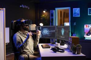 IT expert using virtual reality to make artificial intelligence become sentient, receiving hello greeting from it. Computer scientist with VR glasses on working to achieve AI superintelligence photo