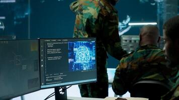 IT software engineer collecting real time data from neural network AI brain, machine learning and data mining algorithms to assist troops with defense missions. Cognitive computing. Camera A. photo