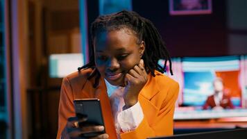 College student doing her homework at laptop and texting on phone, enjoying school break to check social media apps. Girl researching for assignments and using smartphone. Camera A. photo