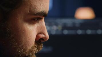 Developer in home office concentrating hard while doing coding on computer, extreme close up shot. Focus on IT admin paying close attention to screen while writing lines of code, camera A photo