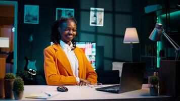 Portrait of business student creating online surveys or questionnaires for research projects, adding authentic information in her final bachelor paper. Pupil smiling and feeling pleased. Camera B. photo