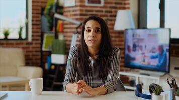 POV of job candidate remotely being interviewed via internet videocall. Portrait of indian woman answering HR interview questions during videoconference meeting while staying at home photo