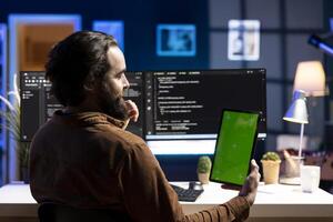 Admin using isolated screen tablet to filter malicious traffic from cybercriminals attempting to corrupt company data. IT expert working on mockup portable device, preventing malware attacks photo