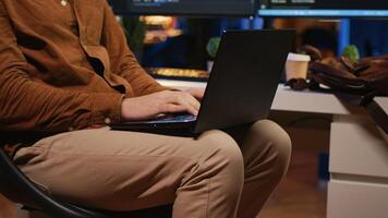 Remote programmer starting job shift in personal office at home, taking laptop out of bag. Teleworker unpacking backpack, writing lines of code on notebook keyboard, camera A close up photo