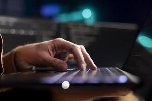 Cybersecurity expert using laptop to look for company security vulnerabilities and prevent malware infections. Developer installing fortified code on notebook to prevent cyberattacks, close up shot photo